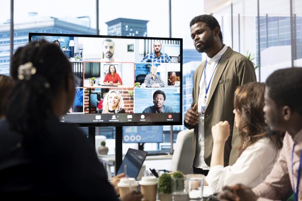 Marketing team analyzing big data insights on online videoconference with the advisory board, creating detailed infographics to present their progress and achieve goals. Remote presentation.